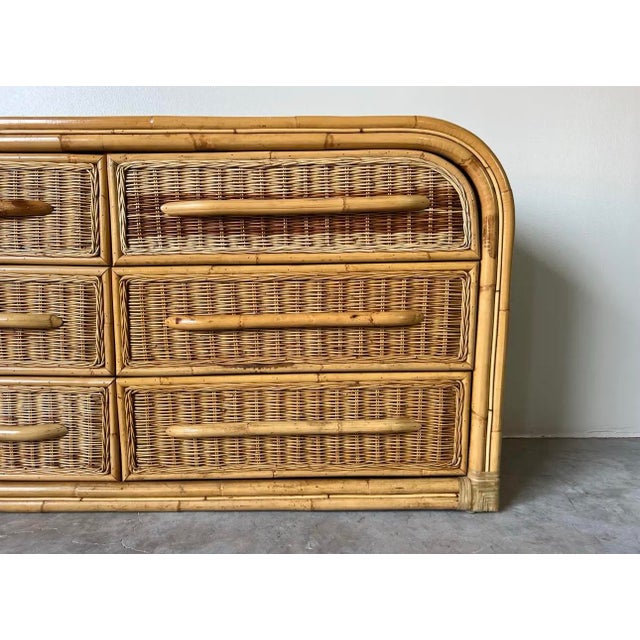 Fabulous vintage organic Modern bamboo waterfall dresser. Features bamboo and rattan construction, waterfall top, six...