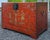 Antique 19th century Chinese storage trunk with red lacquer finish and gold decoration. Crafted in elm with dovetailed and...