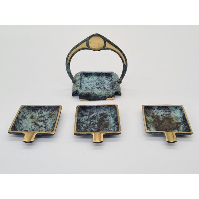 A unique, complete set of three decorative ashtrays with a stand, designed in the distinctive Art Deco style with Arts &...