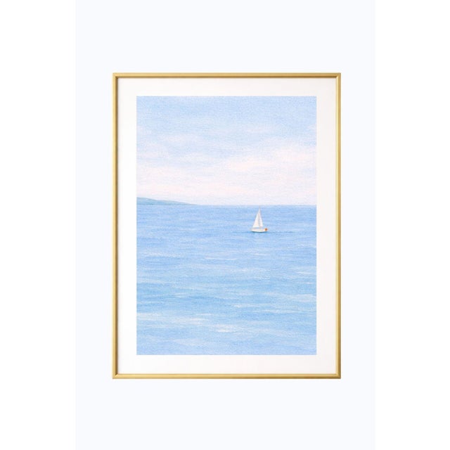 Minimalist sailboat seascape wall art featuring a solitary white sailboat drifting across calm blue water beneath a soft,...