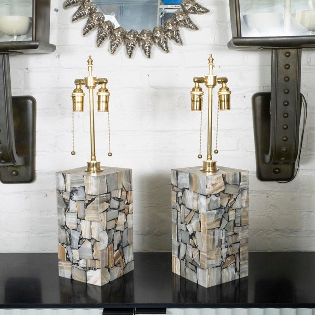 Pair of mosaic style onyx inlay table lamps. Lamps feature an interior light operated by an integrated switch.