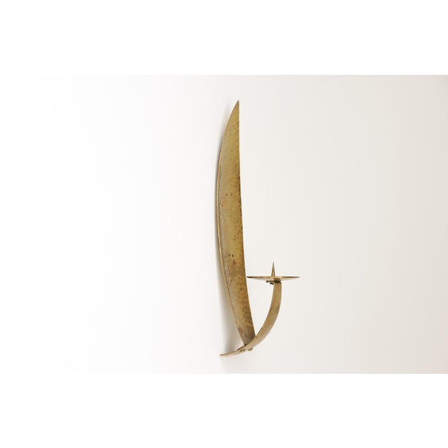 Wall lamp (candle holder) by Alfred Schäfter in the shape of a lance-shaped leaf, made of hammered brass. Germany, circa...