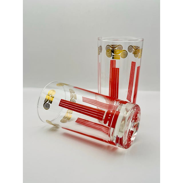 A pair of vintage tumblers decorated with stylized Ionic columns.