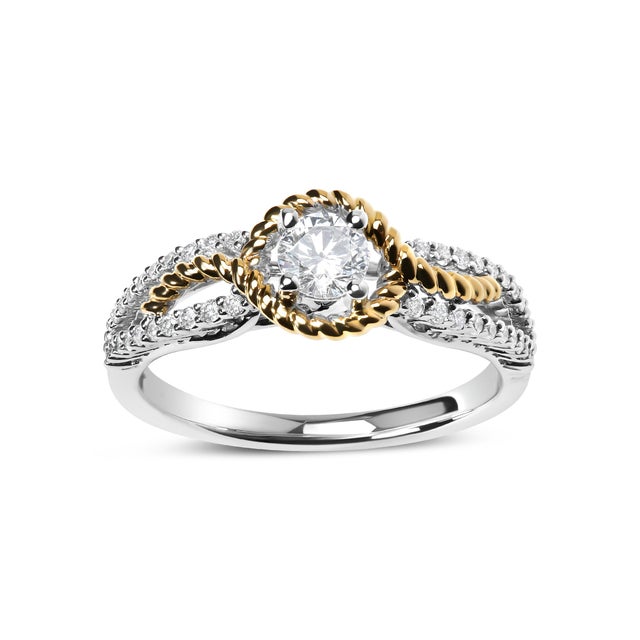 Immerse yourself in the sheer elegance of this 14K two-toned gold engagement ring, where luxury and unique design...