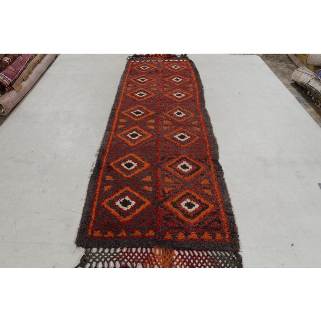 Hand knotted in wool originating circa 1910-1920, this antique runner hails from a select line made in Iraq—one of the...