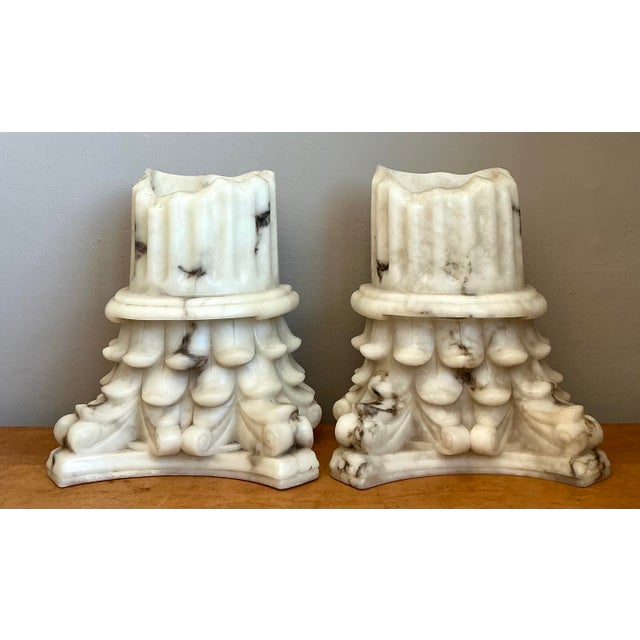 This elegant pair of wall sconces features a timeless Neoclassical design inspired by classical Corinthian architectural...