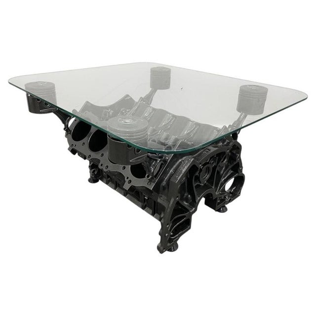A striking fusion of automotive engineering and contemporary furniture design, this sculptural coffee table has been...