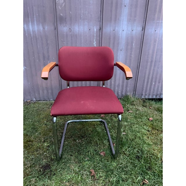 Vintage Cesca-Style Upholstered Armchair A classic Cesca-style armchair featuring a vibrant orange upholstered seat and...