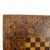 This antique folk art game board, dating to approximately 1900, features intricate parquetry work. The central playing...