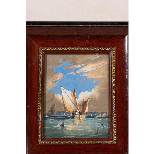 Original seascape watercolor presented in a cherry-hued oak frame. Soft washes of color and coastal subject matter create...
