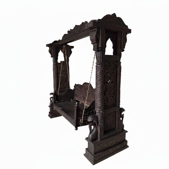This hand carved solid wood Indian swing, also known as a traditional jhoola, is a striking blend of craftsmanship,...