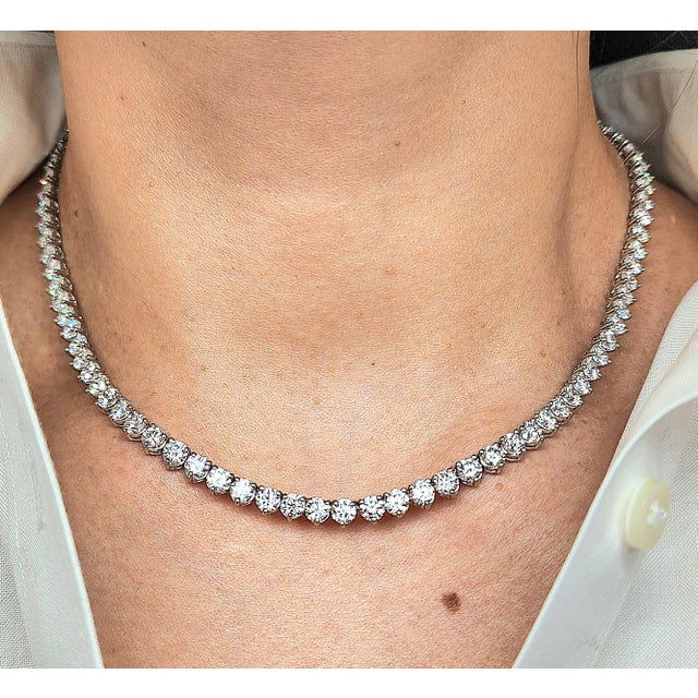 This gorgeous 24.10 ct diamond tennis necklace has 95 diamonds set in platinum and is 16 inches long. The diamonds brag...