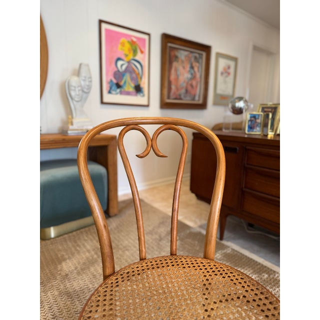 A vintage bentwood Thonet “sweetheart” chair, circa 1950s. Made in Romania, the classic Thonet style cafe chair has a...