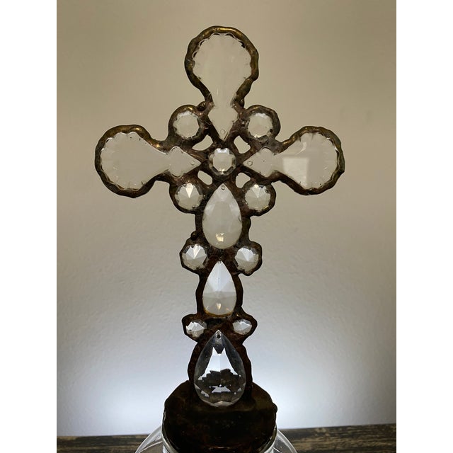 This one-of-a-kind assemblage sculpture pairs a clear rectangular glass bottle with a handcrafted cross composed of...