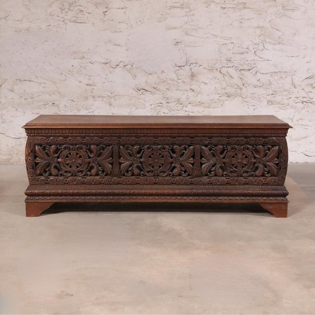 This 19th Century Italian Carved Oak Cassapanca is a monumental and richly detailed antique that reflects the grandeur and...