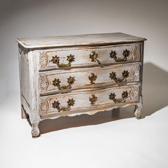 French Chest of Drawers in solid walnut with three drawers and a shaped apron resting on elegantly curved feet. The front...