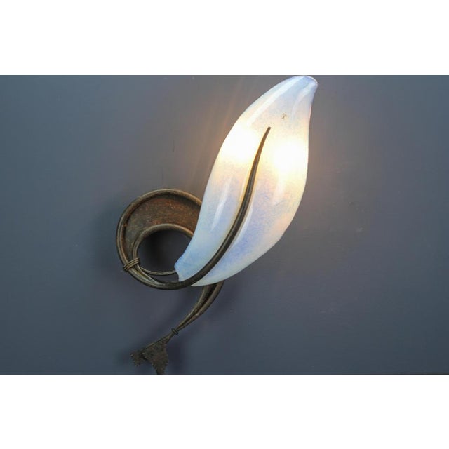Large Italian Vetro Murano Venezia opalescent glass and wrought iron wall light from the late 20th century. This imposing...