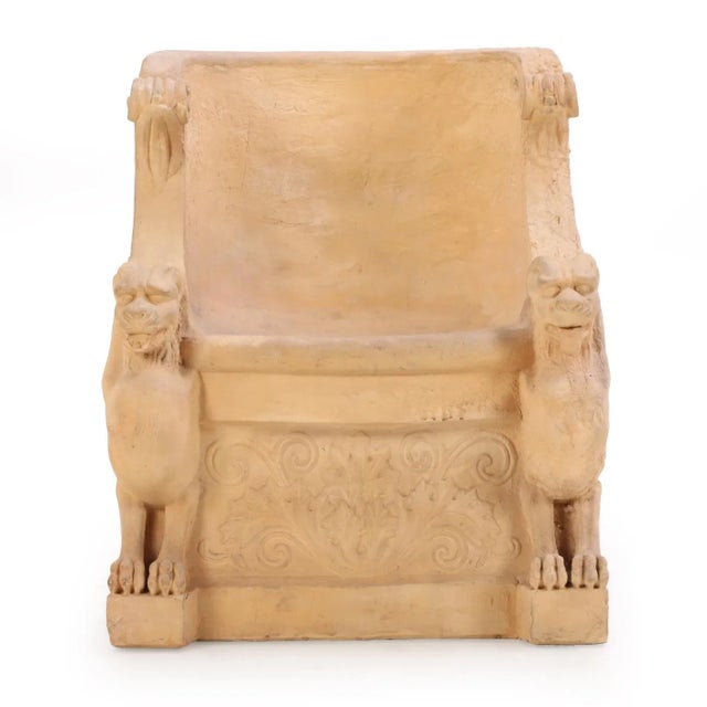 This tub form chair has a rounded back flanked by two chimera with horns and lions faces and paws. The rounded front seat...