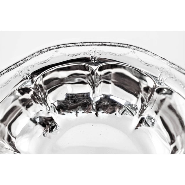 A dainty and charming bowl by one of the great silver companies. A scalloped rim and matching inside; the body compliments...