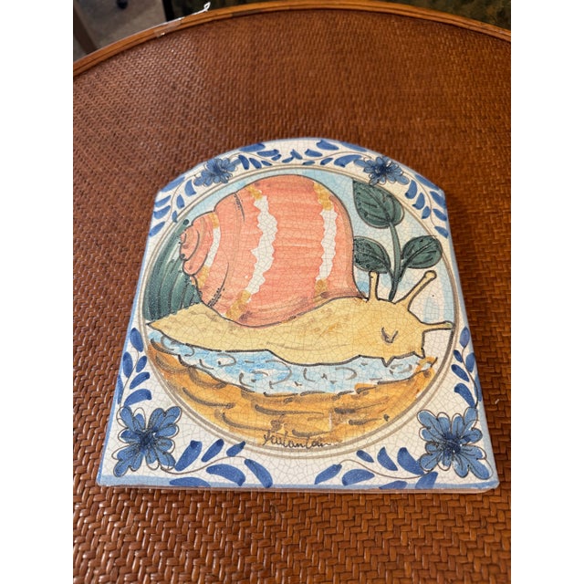 Add a touch of whimsical charm to your space with this vibrant handmade Italian wall plaque. Crafted from clay and shaped...