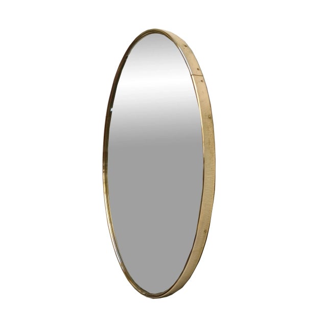 Solid brass wall mirror designed and manufactured in Italy in the 1960s. The brass has its original patina and shows signs...