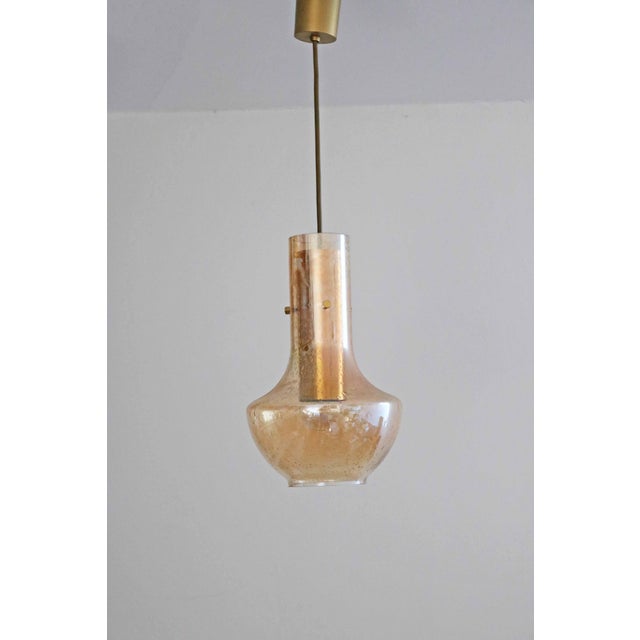 Leclaire & schäfer pendant lamp simple space age design from the 1970s amber-colored bubble glass with an internal brass...