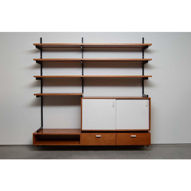 A wall unit in pine with a black painted steel structure. Designed for a house in Antwerp by Belgian interior architect...