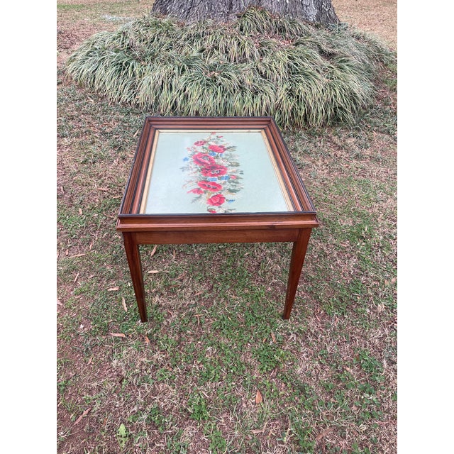 This beautiful table is handcrafted and most likely one of a kind. The table top is a large framed needle point of...