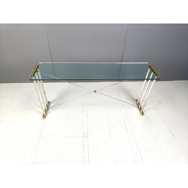Rare brass console table designed by Peter Ghyczy. Ghyczy is known for his bronze/brass tables with integrating the glass...
