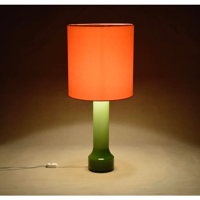 Very colorful table lamp. Green base and orange shade. The designer can be Bengt Orup or Gert Nyström for Hyllinge Glass...