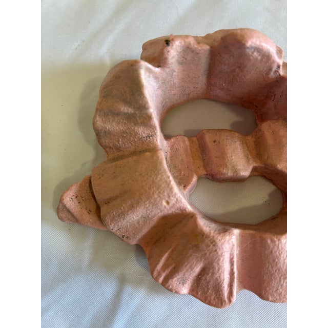 A charming vintage carved wooden wall hanging designed as a flowing ribbon bow. Finished in a soft pink hue, this...