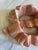 A charming vintage carved wooden wall hanging designed as a flowing ribbon bow. Finished in a soft pink hue, this...