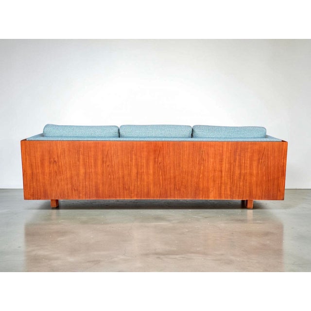 Presented here is a vintage mid century modern teak case sofa, designed in the manner of Milo Baughman. This beautiful...
