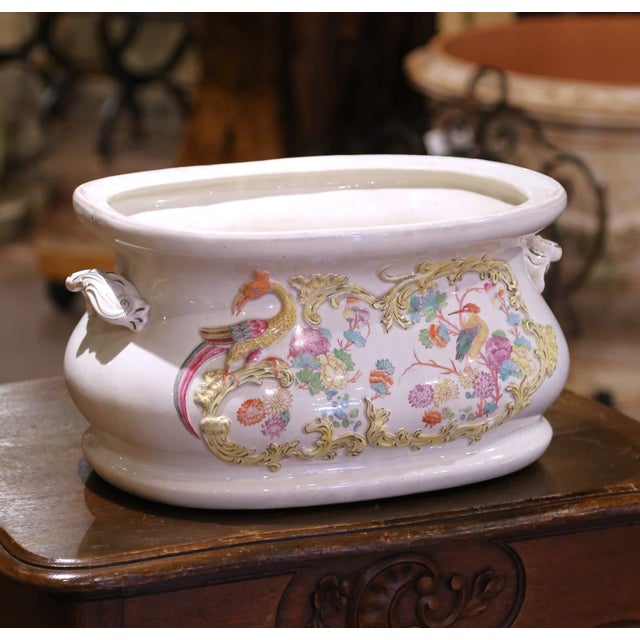 Add a touch of whimsical elegance to your space with this charming 19th-century French faience foot bath. Crafted circa...