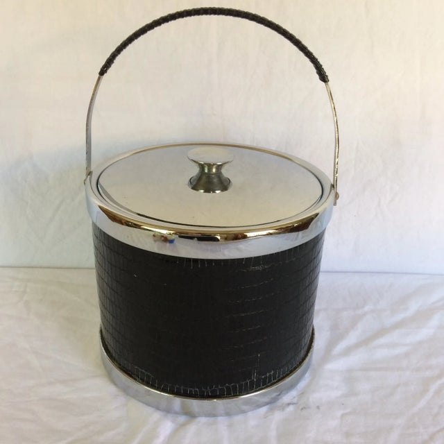 This is truly a Mid-Century Modern black leather wrapped Chrome handled ice bucket with Chrome lid plus trim.
