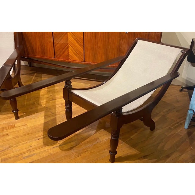 Great pair of vintage mahogany planters chairs with canvas.