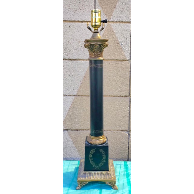 A MidCentury Stiffel Greek Corinthian Column Table Lamp with ebonized metal and brass with Paw feet Measures 6" in width,...