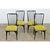 A sleek set of four dining chairs from mid-20th century France attributed to designer Charles Ramos. Their ebonized finish...