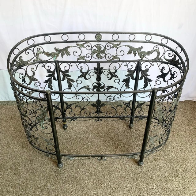 Ornate and timeless, this Maitland Smith-style console table features hand-forged wrought iron in a gracefully rounded...