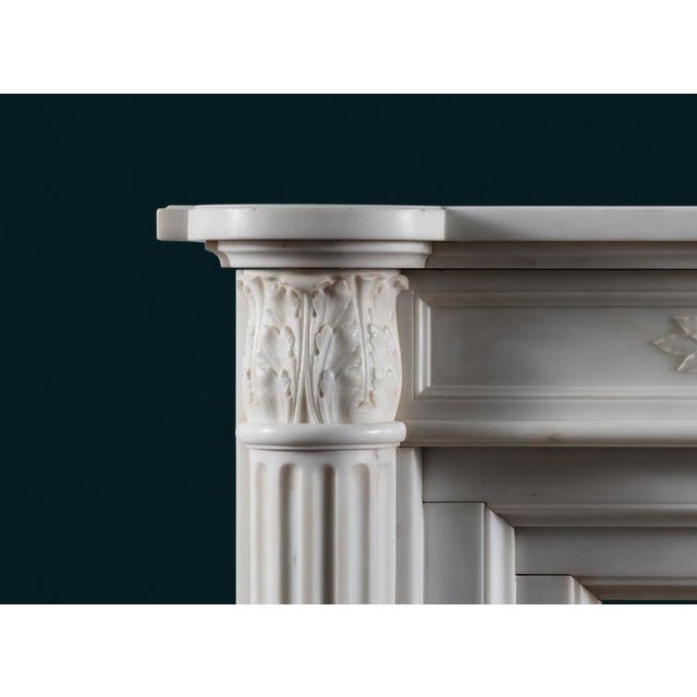 An antique French fireplace surround in the Louis XVI style realised in the very best white Statuary marble, the shaped...