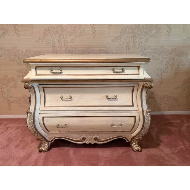Elegant vintage bombe-style dresser featuring dramatic French Provincial / Hollywood Regency styling with a beautifully...