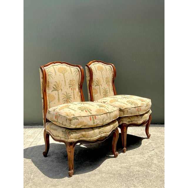 This pair of vintage slipper chairs channels mid-century design at its most refined, pairing a sculptural wood frame with...