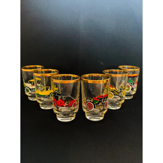 Set of Six Gold Rimmed Ruhrglas Car Lovers Shot Glasses in Original Box This set of six mid-20th century era shot glasses...