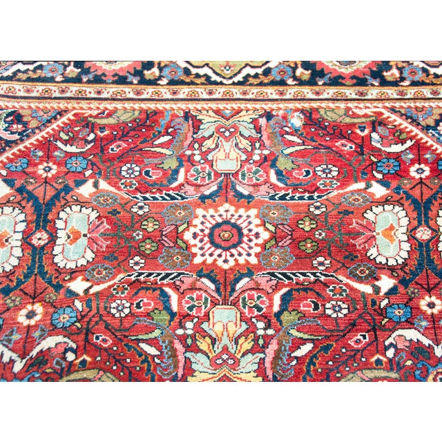 A spectacular early 20th century Persian Mahal rug with an all-over mirrored floral pattern with large and small flowers...