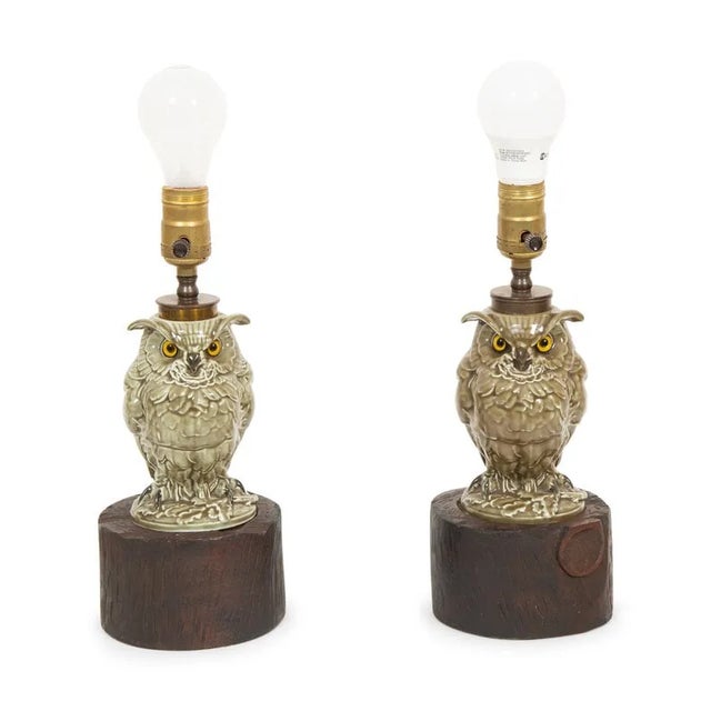 A pair of glazed earthenware owl table lamps. Mid 20th century. Base: 5 1/8” dia.. Body: 4” dia. Height without shade:...