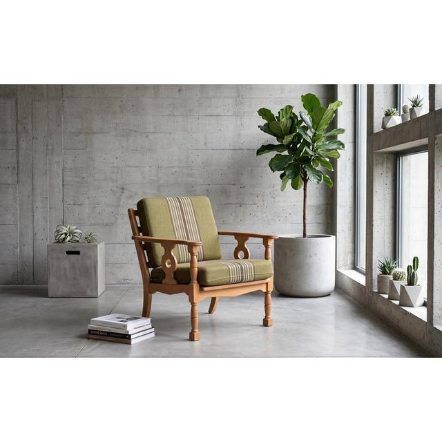 Armchair in solid oak designed by Henning Kjærnulf and produced in Denmark during the 1960s. The chair features finely...