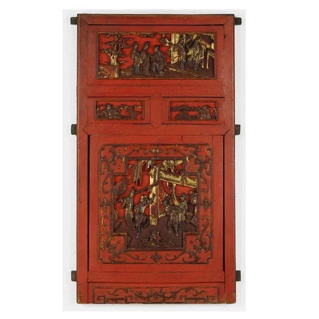 A red-painted wood door panel with painted and parcel-gilt decoration throughout. The scene depicts a celebration. The...