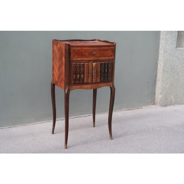 French Louis XV style side table / nightstand. Parisian work around 1920. The doors are decorated with trompe l'oeil...