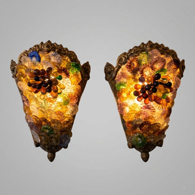 This spectacular pair of wall sconces embodies the exuberance and craftsmanship of Murano's master glassmakers in the...