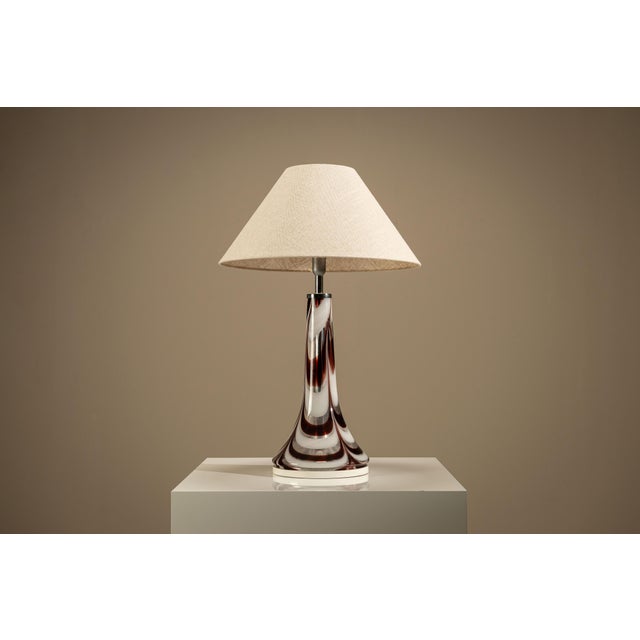 Some objects draw attention through ornament, others through the quiet confidence of their form. This Murano table lamp...